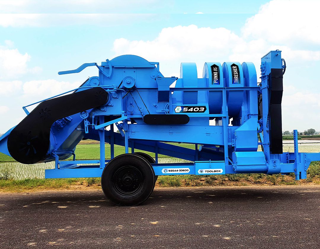A detailed image of the side of the PUNNI 5403 multi-crop thresher, showcasing its advanced features and robust construction.