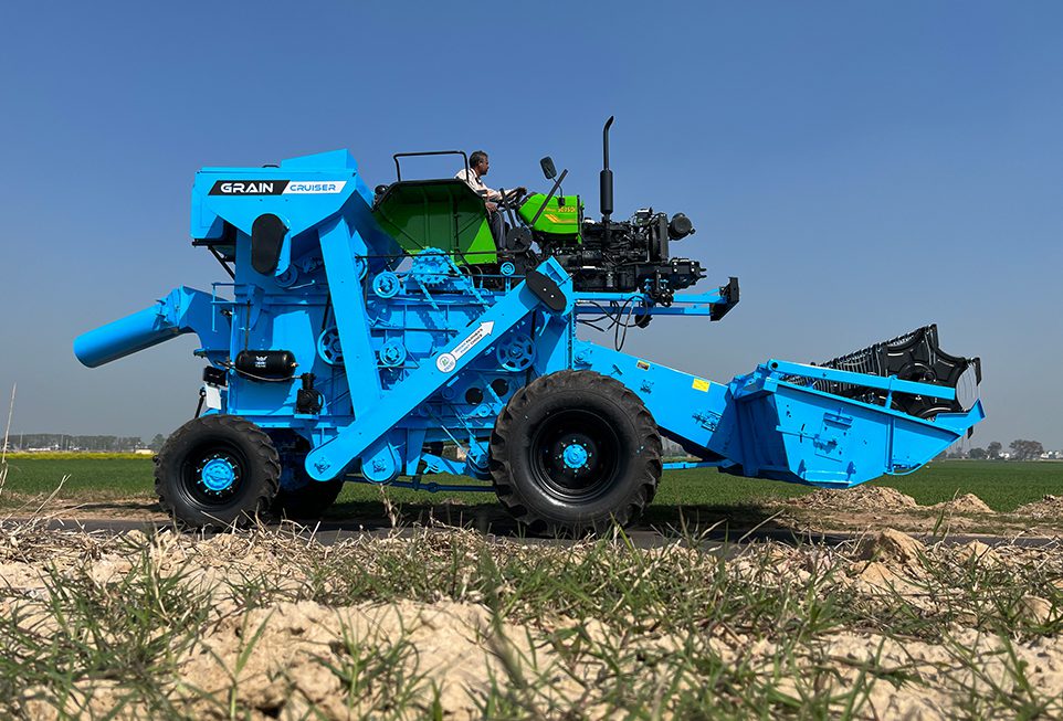 Tractor Mounted Combine Harvester harvesting wheat crop in field